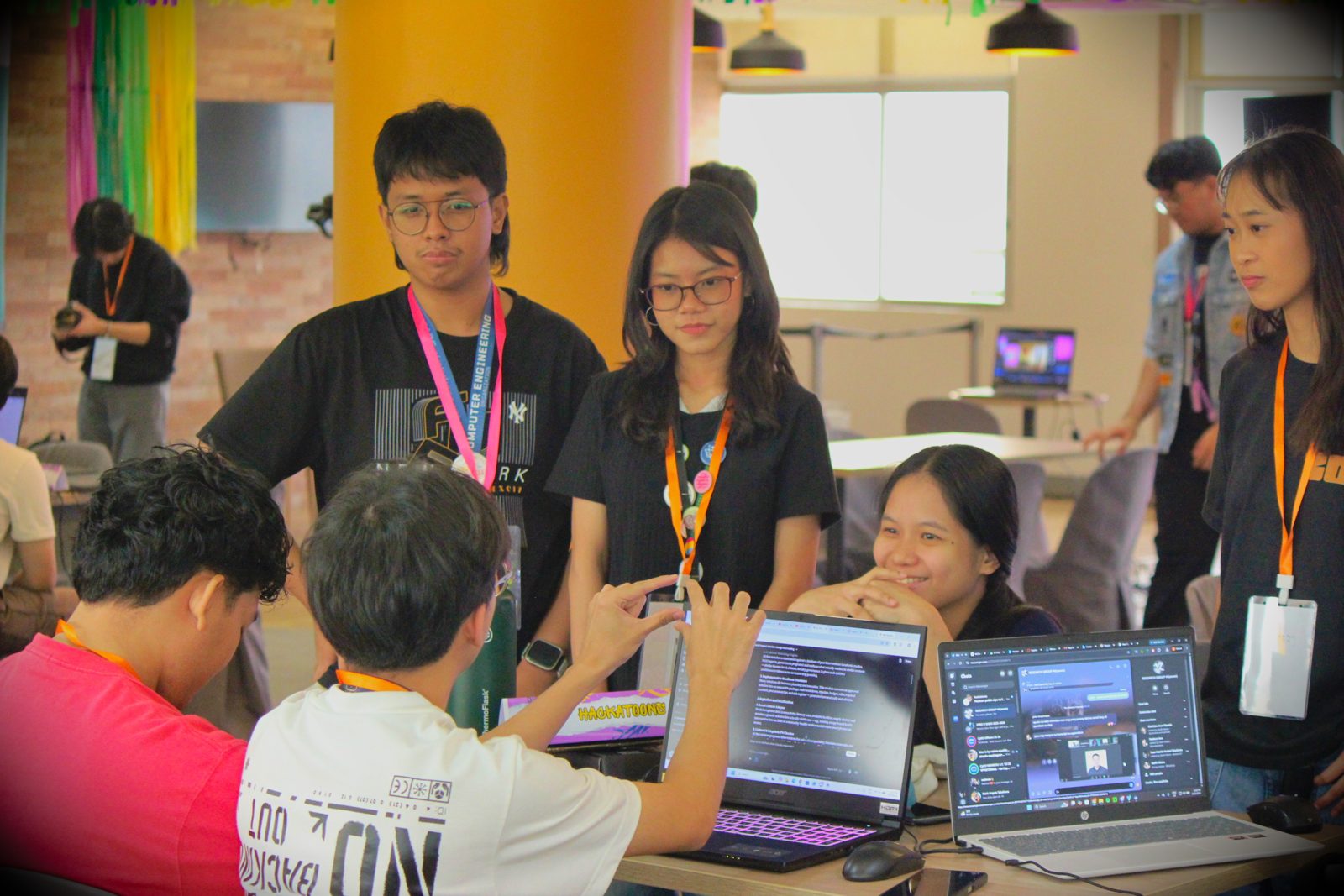 Mentors making rounds at team tables during Create & Conquer 2026