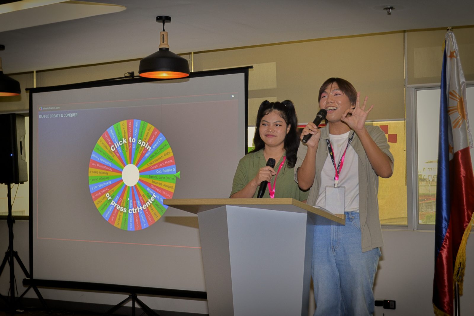Hosts spinning the raffle wheel at Create & Conquer 2026