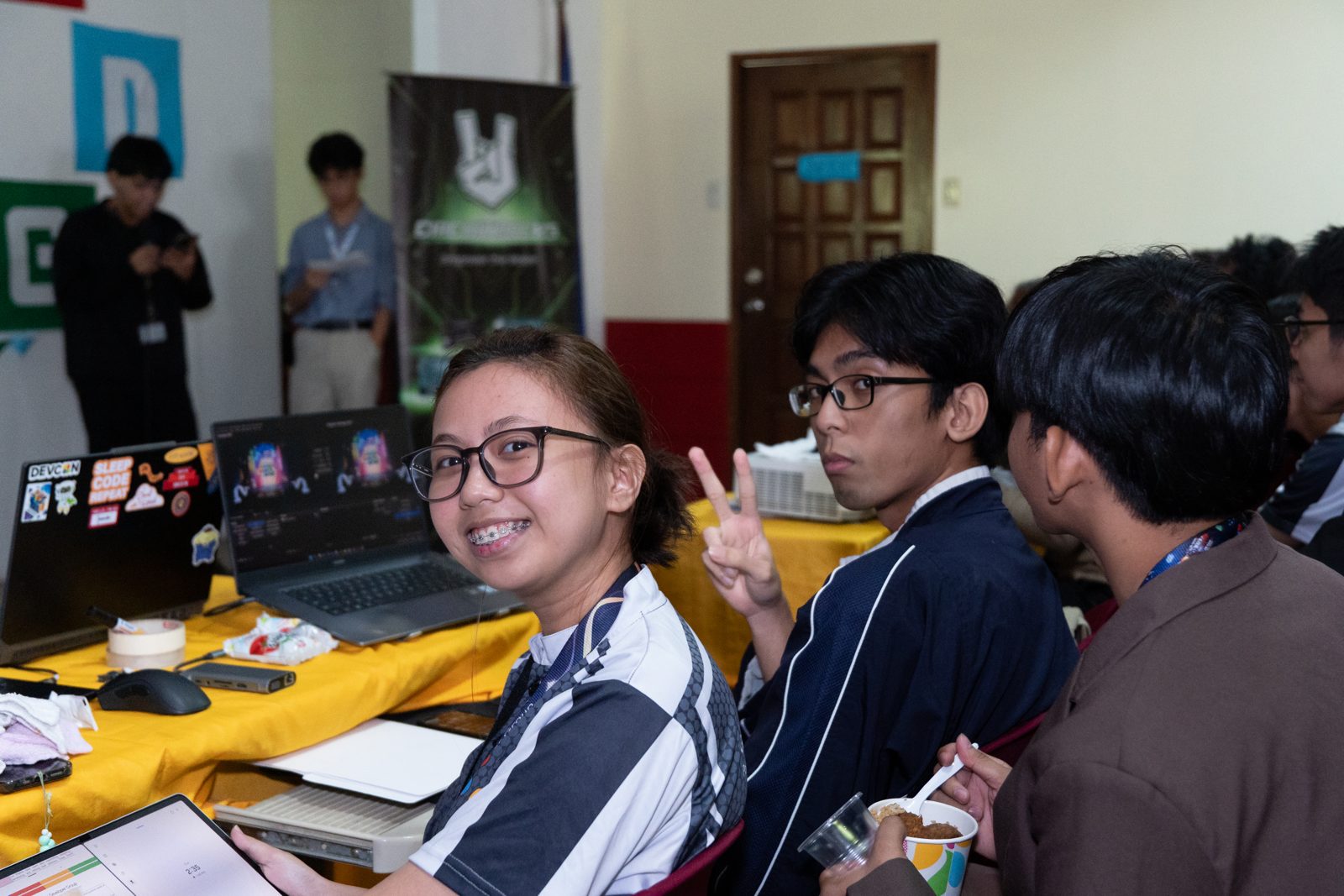 Student teams building at their tables during the SparkFest 2026 hackathon